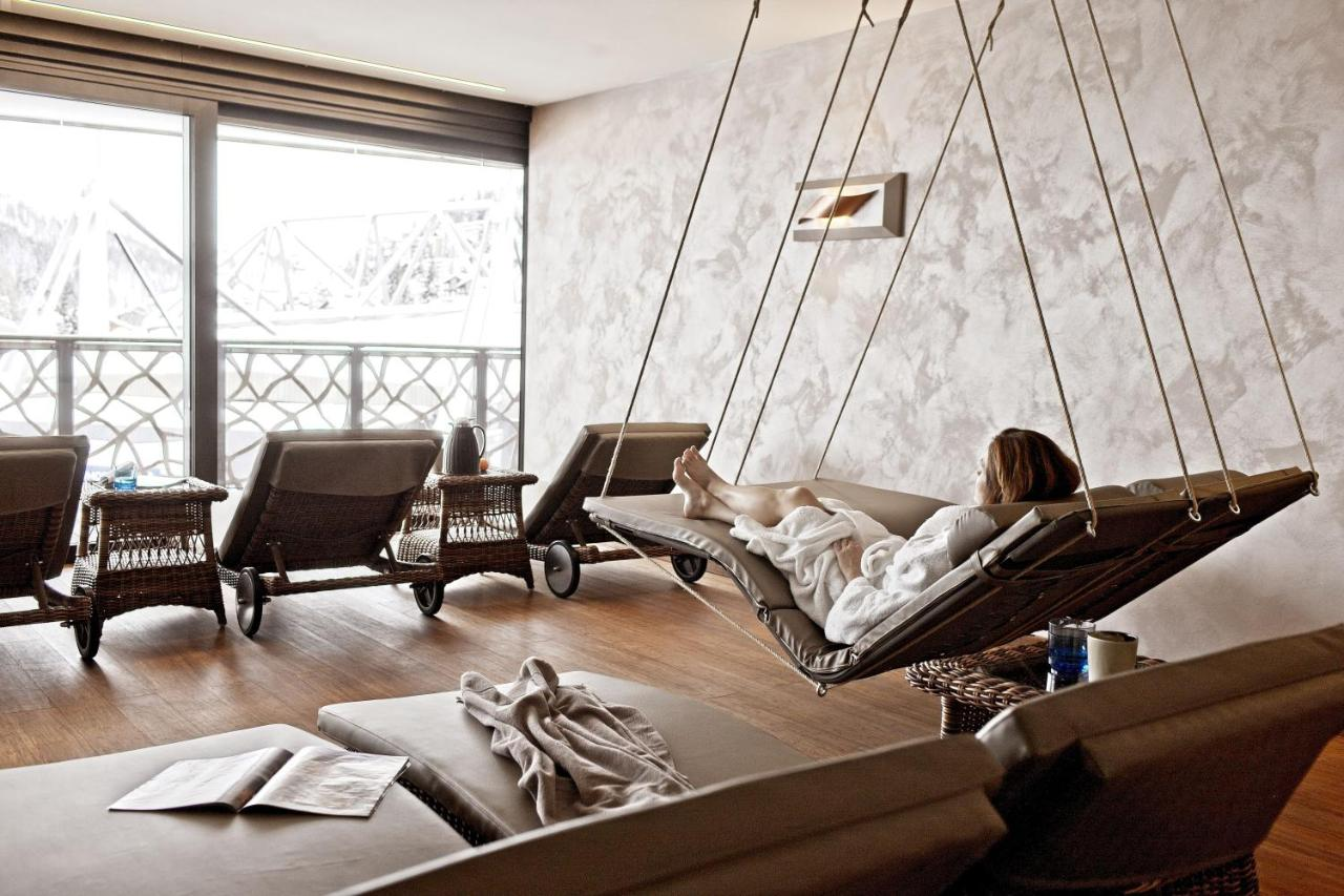 Valsana Hotel Arosa alpine spa relaxation room with hanging rope lounger and mountain view
