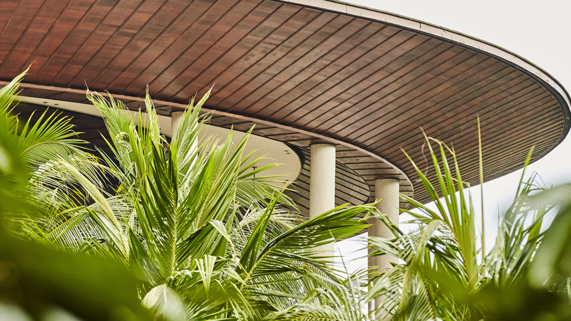 The iconic elliptical lotus roof of Four Seasons Bali at Sayan above the Ayung River valley