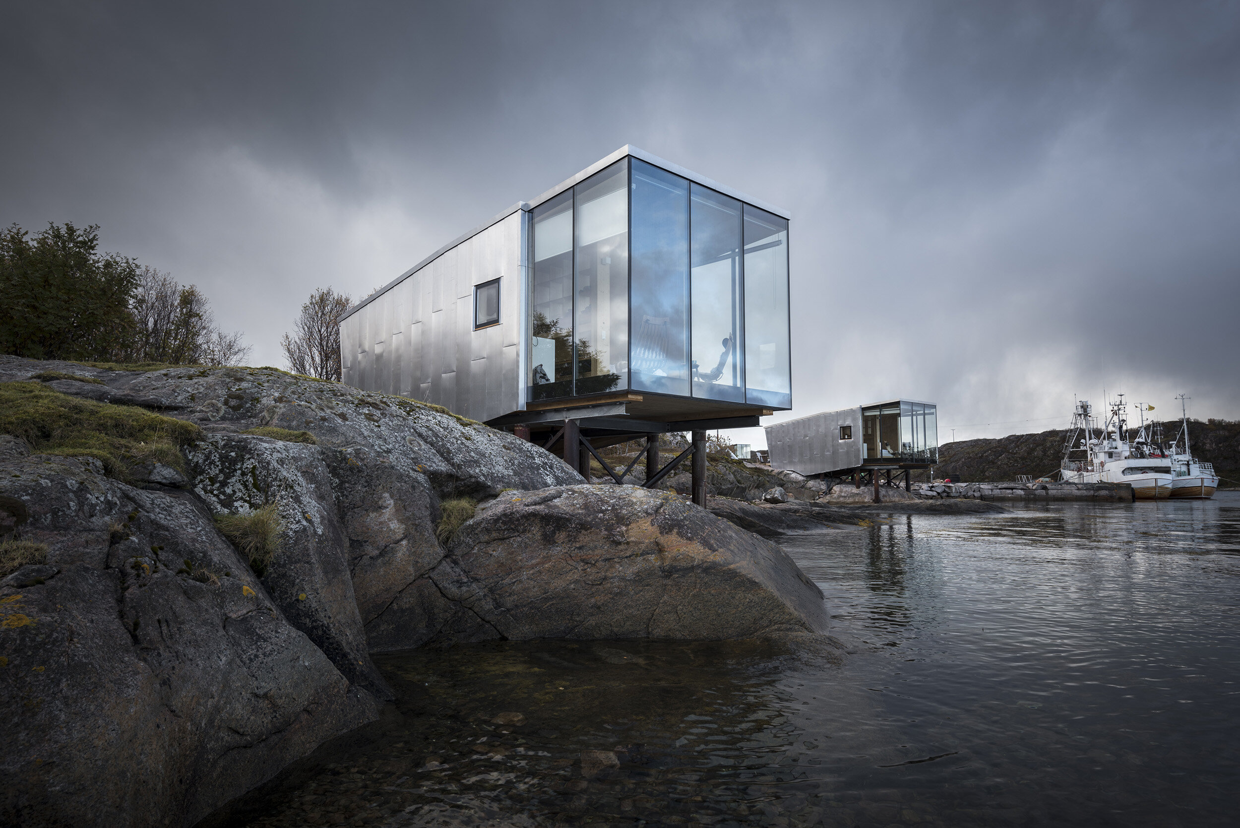 Manshausen sea cabins on stilts over rocky Norwegian coastline, Arctic Norway