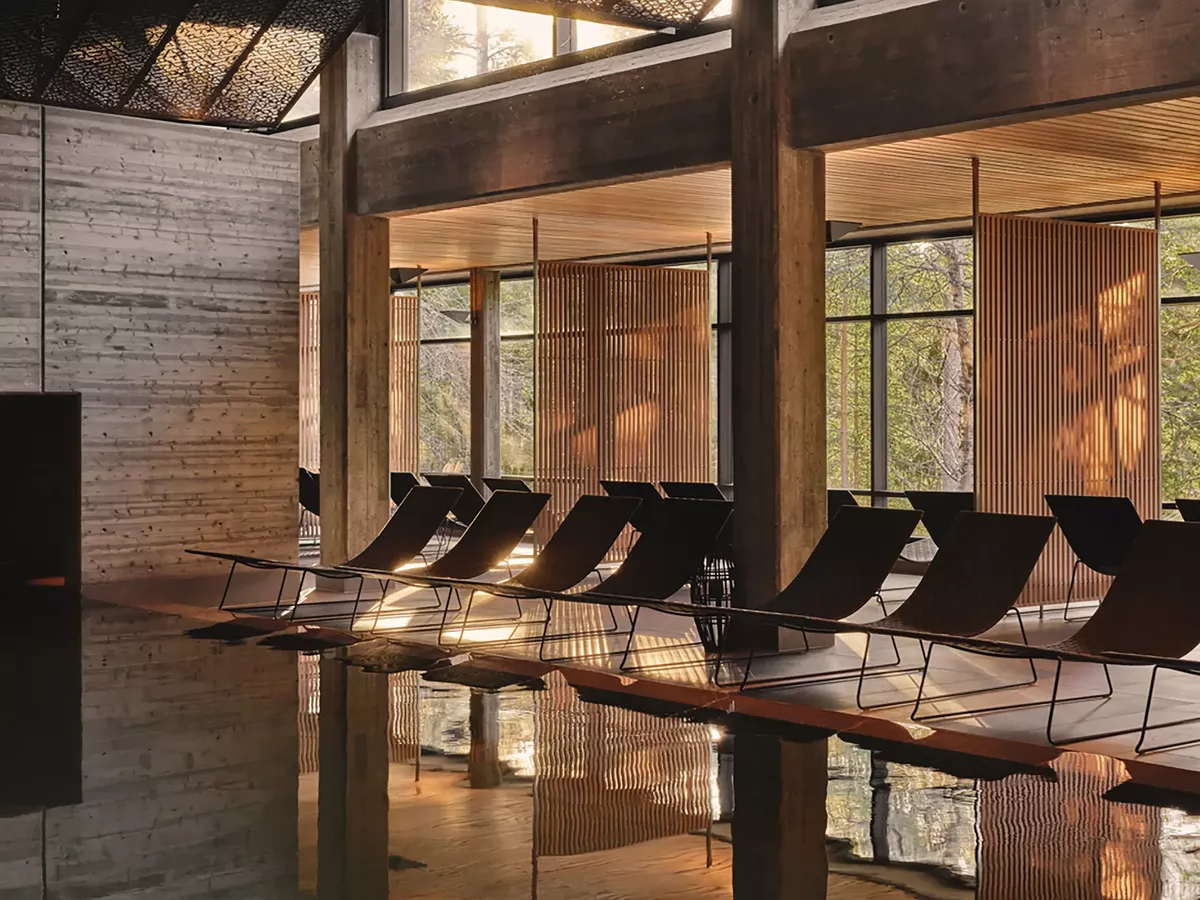 Yasuragi Sweden Japanese-inspired spa pool with loungers, concrete and wood architecture, forest view