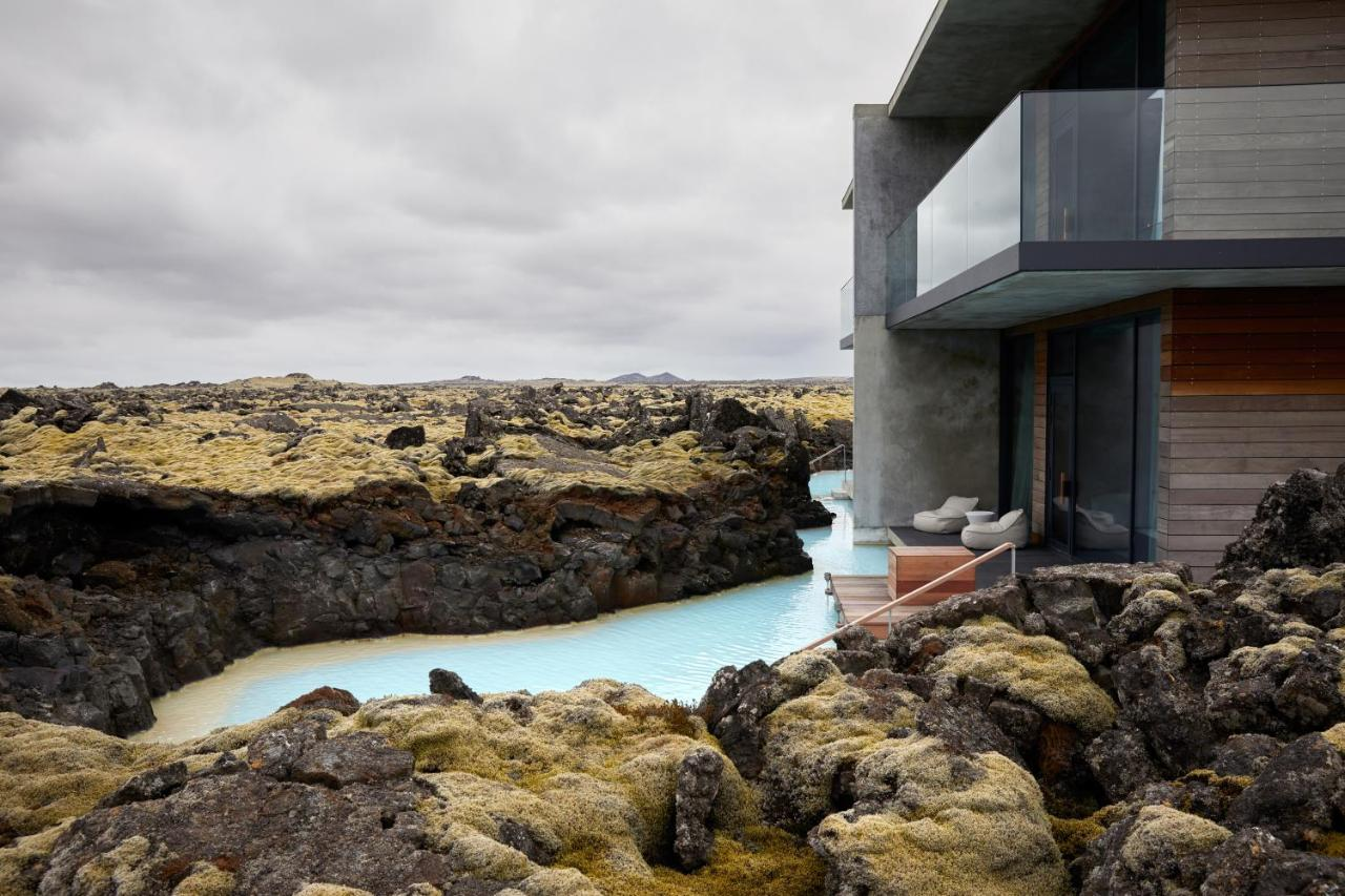 The Retreat at Blue Lagoon Iceland concrete building over milky blue geothermal lagoon, lava field