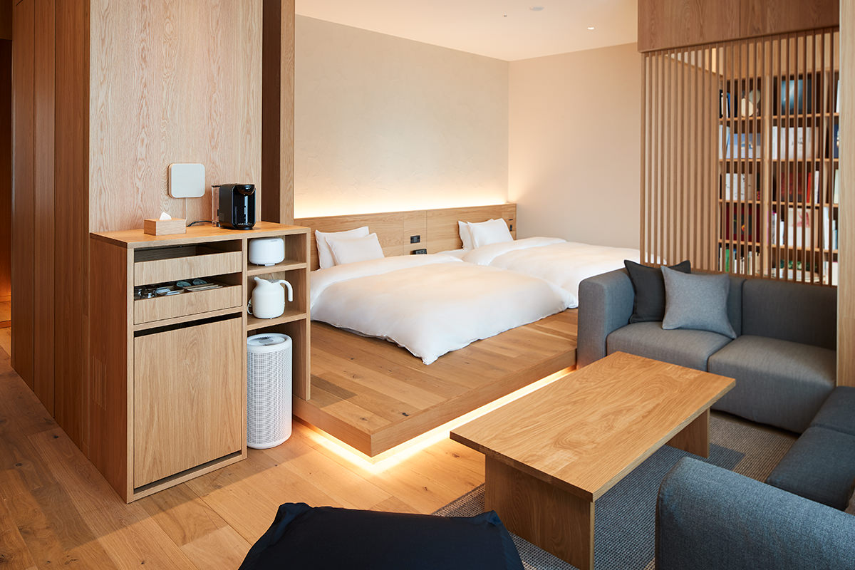 MUJI Hotel Ginza Type B suite with neutral linens, salvaged cedar, and a corner sofa