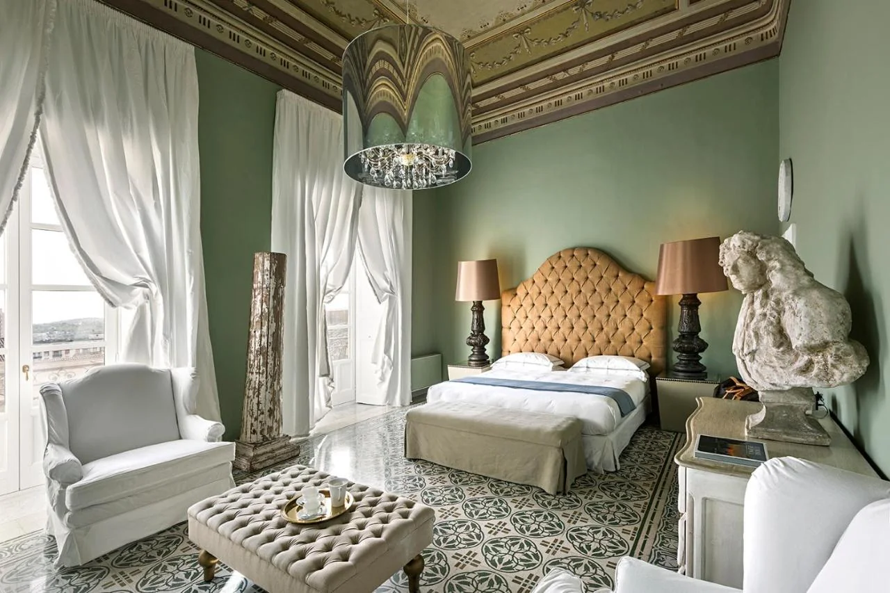 Frescoed bedroom inside the 18th-century Palazzo Nicolaci, home to Seven Rooms Villadorata in Noto, Sicily