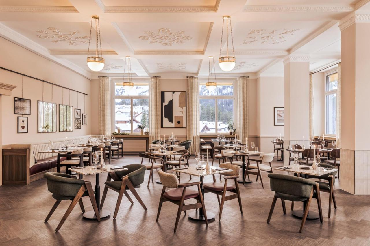 L'Armancette elegant Belle Époque dining room with ornate plaster ceiling and snow outside windows